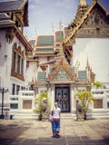 A young blonde girl stands in front of a temple in Thailand stock images A young blonde girl stands in front of a temple in Thailand stock images