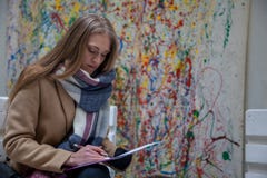 Young blonde woman siting on bench and writing. stock images Young blonde woman siting on bench and writing. stock images