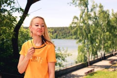 Young blonde woman in yellow t-shirt and sunglasses enjoying sunny day in the park royalty free stock photos Young blonde woman in yellow t-shirt and sunglasses enjoying sunny day in the park royalty free stock photos