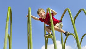 Brave young boy cimbing on playframe. royalty free stock image Brave young boy cimbing on playframe. royalty free stock image