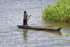 Young Boy Paddling A Dugout In Lake Malawi Royalty Free Stock Images