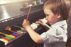 Young boy painting piano keys. Fine arts and music. Stock Image Young boy painting piano keys. Fine arts and music. Stock Image
