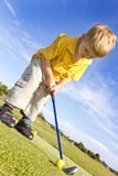 Young boy playing Golf
