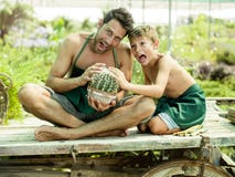Young boy playing with his father in a greenhouse stock photos Young boy playing with his father in a greenhouse stock photos