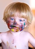 Young Boy With Face Covered In Colourful Paint Royalty Free Stock Photography