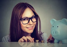 Charming woman with coins and piggy bank stock photos Charming woman with coins and piggy bank stock photos
