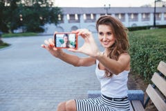 Young brunette woman in park doing selfie stock photos Young brunette woman in park doing selfie stock photos