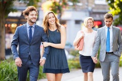 Young Business Couples Walking Through City Park Together