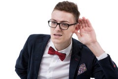 Young business man cupping hand behind ear on white background - stock photos Young business man cupping hand behind ear on white background - stock photos