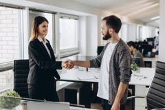 Young business people shaking hands in the office. Finishing successful meeting royalty free stock photos Young business people shaking hands in the office. Finishing successful meeting royalty free stock photos