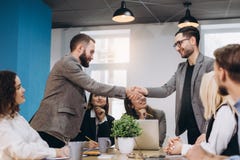 Young business people shaking hands in the office. Finishing successful meeting stock photography Young business people shaking hands in the office. Finishing successful meeting stock photography