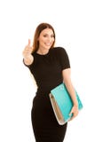 Young business woman in black dress holds a folder shows thumb u Stock Images Young business woman in black dress holds a folder shows thumb u Stock Images