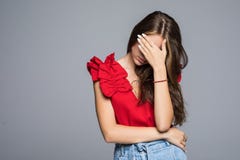 Young woman hides her face isolated on a gray background royalty free stock photography Young woman hides her face isolated on a gray background royalty free stock photography