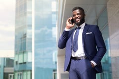 Young businessman with a beard in blue suit speaking on the phone outside with copy space royalty free stock photos Young businessman with a beard in blue suit speaking on the phone outside with copy space royalty free stock photos