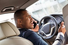 Young businessman driver driving the car answering phone call angry back seat view stock image Young businessman driver driving the car answering phone call angry back seat view stock image