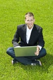 Young Businessman On The Grass With His Laptop Royalty Free Stock Images Young Businessman On The Grass With His Laptop Royalty Free Stock Images