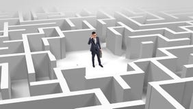Businessman standing in a middle of a maze royalty free stock photo Businessman standing in a middle of a maze royalty free stock photo