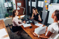 Young businesswomen at presentation. Female colleague showing a diagram explaining new business strategy Royalty Free Stock Image Young businesswomen at presentation. Female colleague showing a diagram explaining new business strategy Royalty Free Stock Image