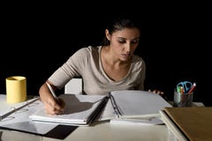 Young busy beautiful Spanish girl studying at home late night looking preparing exam concentrated royalty free stock photo Young busy beautiful Spanish girl studying at home late night looking preparing exam concentrated royalty free stock photo