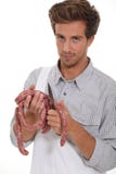 Young butcher cutting sausages stock image Young butcher cutting sausages stock image