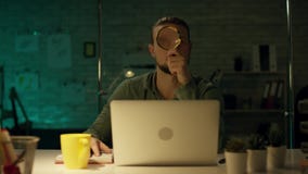 Young Capable Architectural Engineer Working Late Hours in His Office. Office is Dark Only His Table Light is On stock video footage Young Capable Architectural Engineer Working Late Hours in His Office. Office is Dark Only His Table Light is On stock video footage