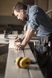 Young carpenter at work stock photo Young carpenter at work stock photo