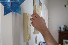 Man answers to intercom or doorphone royalty free stock images Man answers to intercom or doorphone royalty free stock images