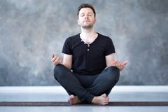 Yoga male beginner practicing yoga sitting in pose and meditates royalty free stock photography Yoga male beginner practicing yoga sitting in pose and meditates royalty free stock photography