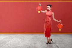 Young chinese woman in a traditional clothing holding red lanterns royalty free stock photography Young chinese woman in a traditional clothing holding red lanterns royalty free stock photography