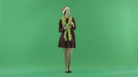 A young Christmas woman calls to someone from the right side on the green screen stock video footage A young Christmas woman calls to someone from the right side on the green screen stock video footage