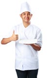 Young cook keeps an empty plate with thumb up stock photography Young cook keeps an empty plate with thumb up stock photography