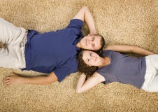 Young couple on beige carpet