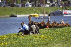 The young couple considers the Vikings ship which has appeared on the river. royalty free stock photography The young couple considers the Vikings ship which has appeared on the river. royalty free stock photography