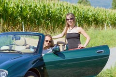 A young couple in a convertible car. A young couple in a green convertible car Royalty Free Stock Photography A young couple in a convertible car. A young couple in a green convertible car Royalty Free Stock Photography