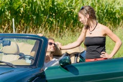 A young couple with convertible car. A young couple with green convertible car Royalty Free Stock Image A young couple with convertible car. A young couple with green convertible car Royalty Free Stock Image