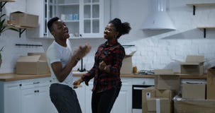 Young couple dancing in their new home
