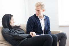 Young couple disputing problem while sitting on sofa royalty free stock images Young couple disputing problem while sitting on sofa royalty free stock images
