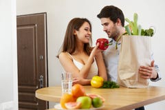 Young Couple with Grossery Bag full of Vegetables. Healthy Lifes Stock Photo Young Couple with Grossery Bag full of Vegetables. Healthy Lifes Stock Photo