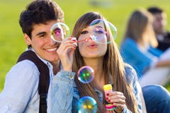 Young Couple Having Fun With Soap Bubbles In The Park Stock Photos Young Couple Having Fun With Soap Bubbles In The Park Stock Photos