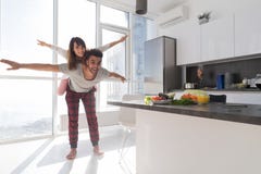Young Couple In Kitchen, Lovers Hispanic Man Carry Asian Woman Modern Apartment