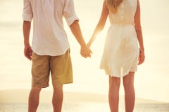 Young couple in love on the beach sunset stock image Young couple in love on the beach sunset stock image