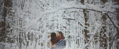 Young couple in love kissing in cold forest royalty free stock photo Young couple in love kissing in cold forest royalty free stock photo