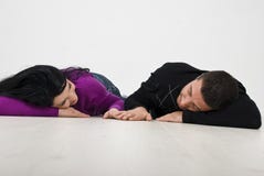 Young Couple Lying And Holding Hands Royalty Free Stock Photography