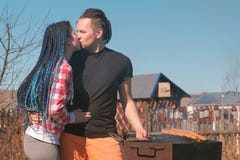 Young couple of man and woman are roasting cutlets and bread burgers on the grill. Family day off royalty free stock images Young couple of man and woman are roasting cutlets and bread burgers on the grill. Family day off royalty free stock images