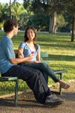 Young Couple On A Park Bench -- Vertical Stock Photo
