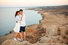 Young couple on the rock with the spectacular view on the background stock photography Young couple on the rock with the spectacular view on the background stock photography