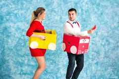 Young couple in a toy cars stock images Young couple in a toy cars stock images