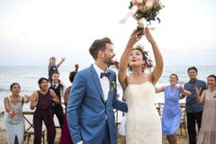 Young couple in a wedding ceremony at the beach Stock Image Young couple in a wedding ceremony at the beach Stock Image