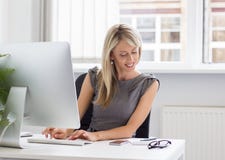 Young creative woman working with computer stock image Young creative woman working with computer stock image