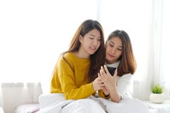 Young cute asia lesbian couple using smart phone with happiness at home, lgbt, homosexual, lesbian couple lifestyle royalty free stock photo Young cute asia lesbian couple using smart phone with happiness at home, lgbt, homosexual, lesbian couple lifestyle royalty free stock photo
